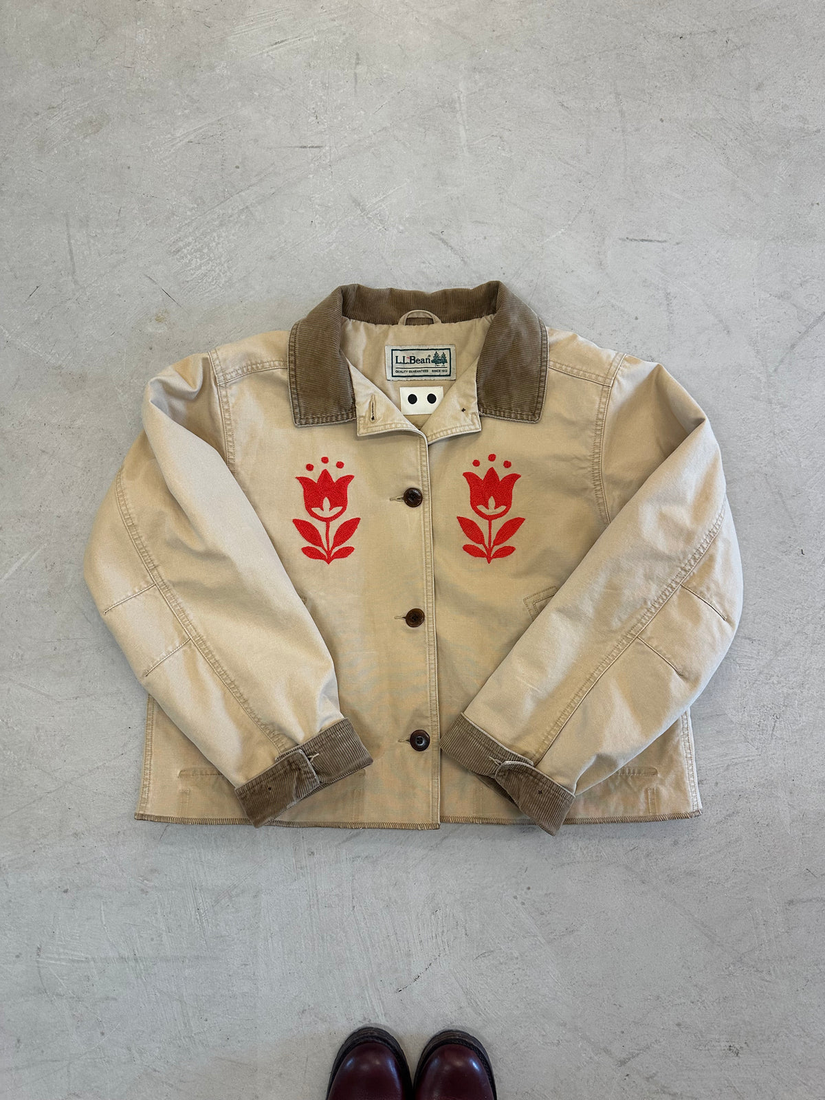 LL Bean Barn Jacket in beige with a pair of red chainstitched tulips