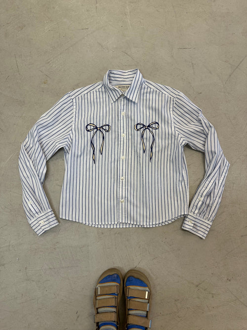 One-of-one vintage cropped long sleeve button-down in white and blue stripe with hand-chainstitched blue and ivory bow embroidery on the chest