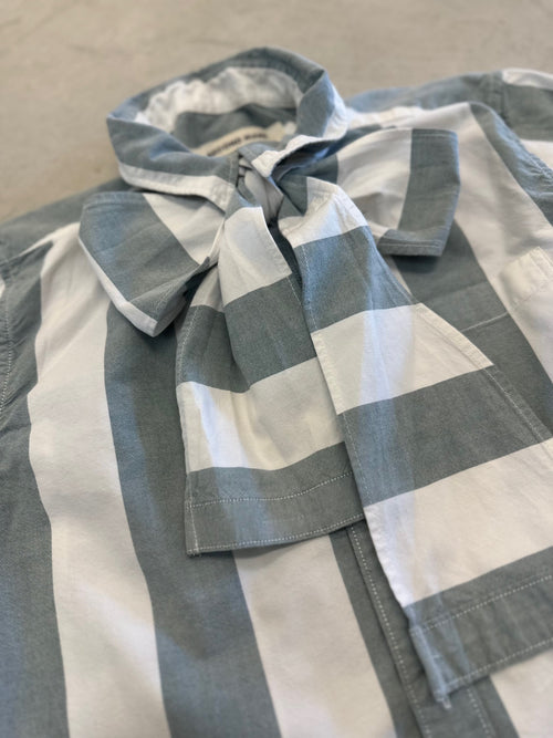 Front view of sage green and ivory wide stripe cropped button-down with bow tie detail