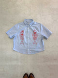 One-of-one vintage cropped short sleeve button-down in light grey/blue with hand-chainstitched red fish embroidery on the chest