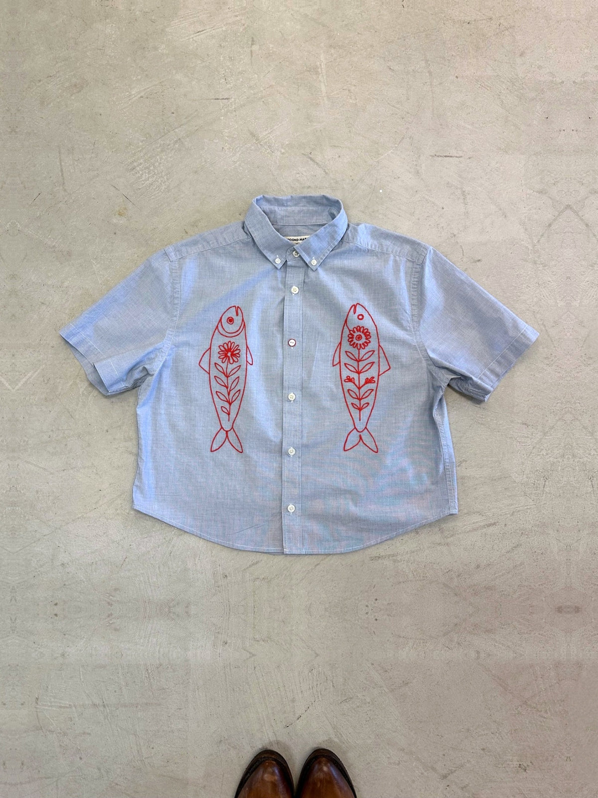 One-of-one vintage cropped short sleeve button-down in light grey/blue with hand-chainstitched red fish embroidery on the chest