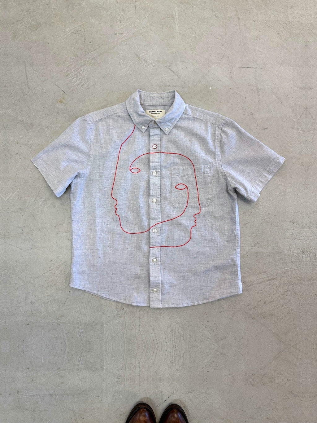 One-of-one vintage cropped short sleeve button-down in light grey with hand-chainstitched red faces embroidery on the chest