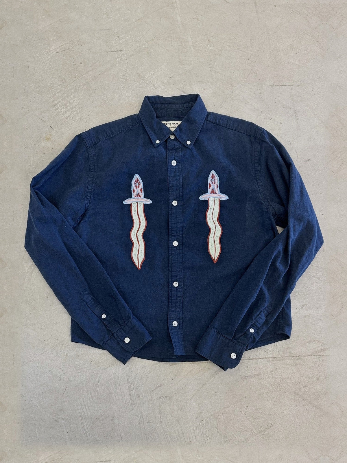 Navy shirt with two chainstitched daggers by Emily Counts