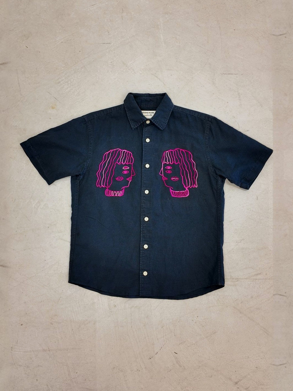 Faces shirt laid flat