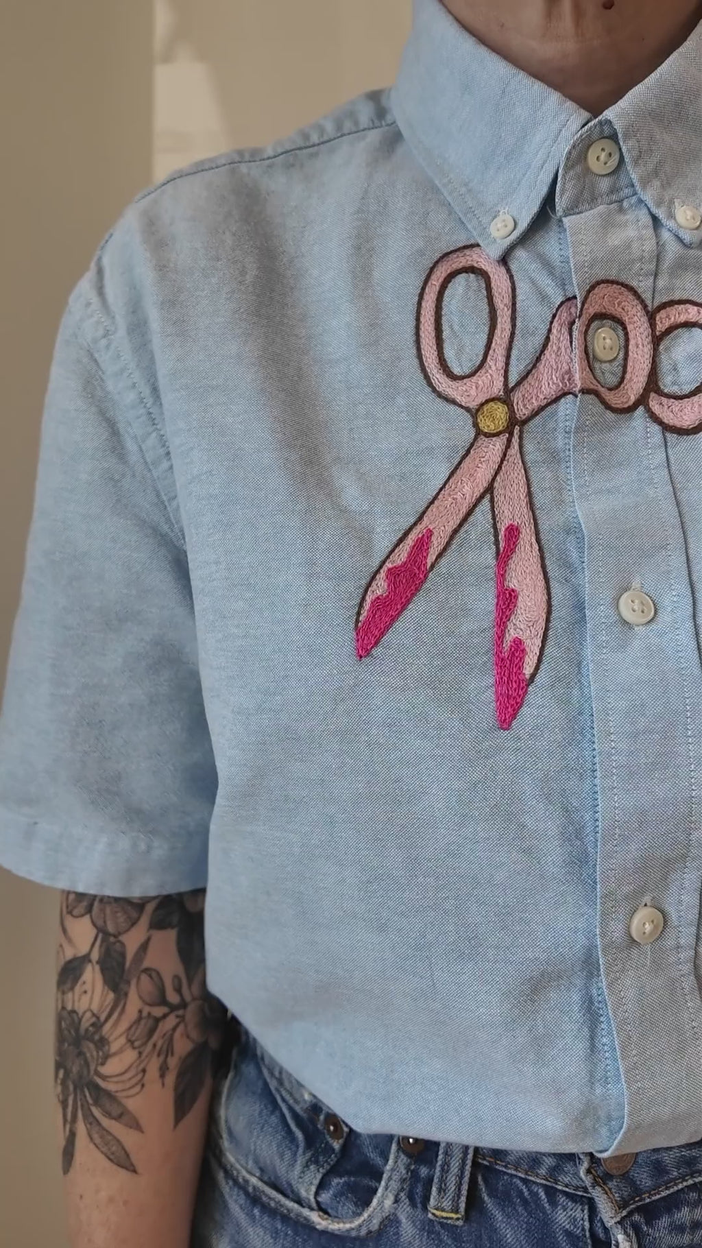 Try-on of the Emily Counts scissors across shirt