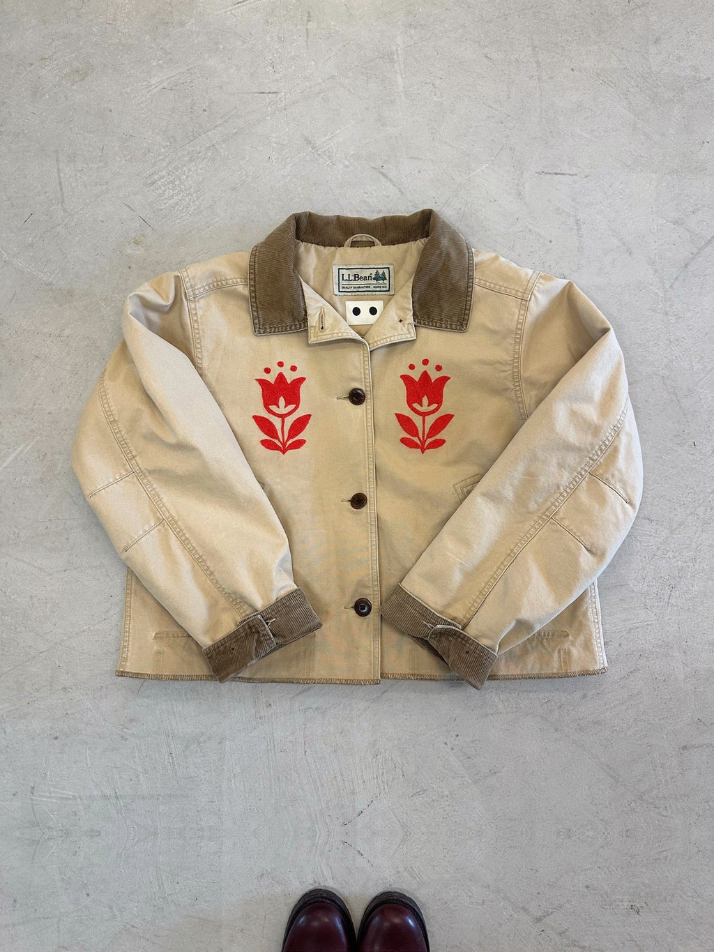 LL Bean Barn Jacket in beige with a pair of red chainstitched tulips